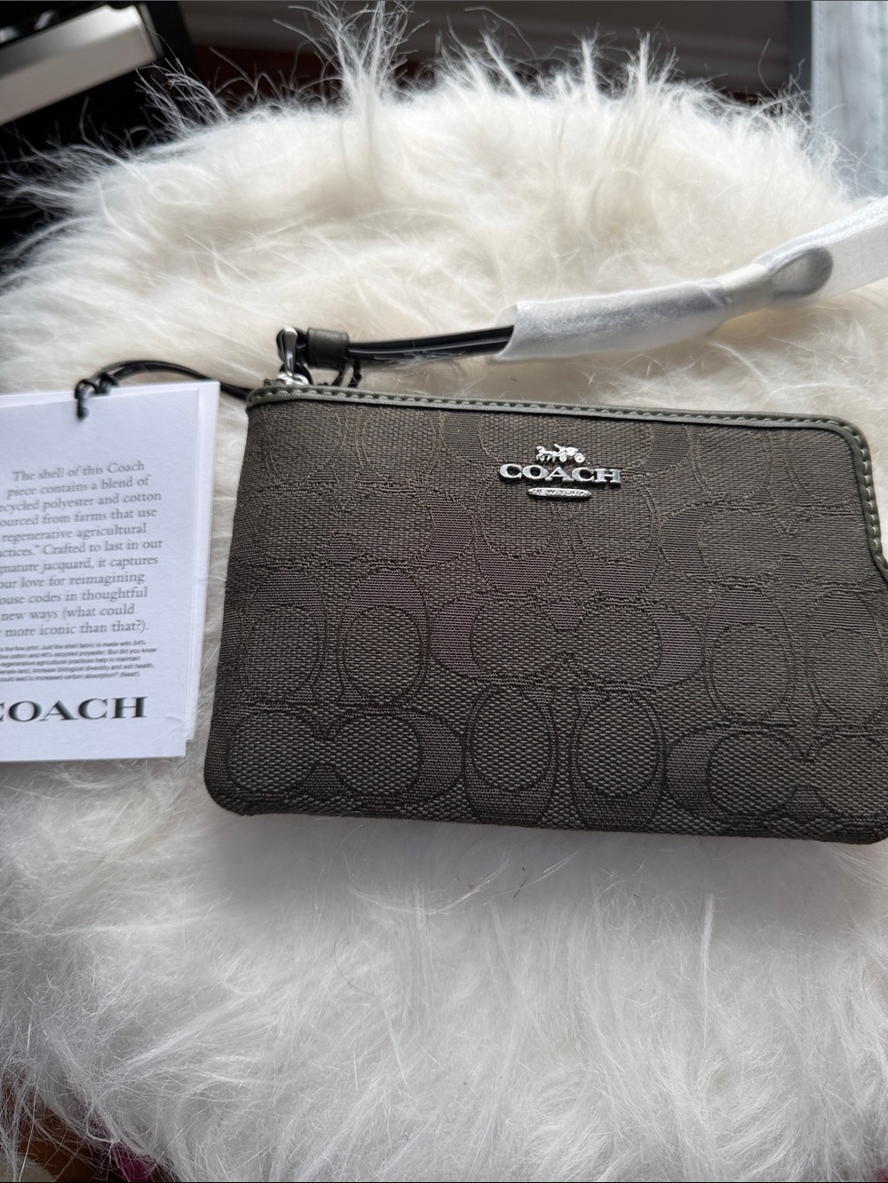 COACH $88 NWT Jacquard Olive corner zip wristlet with card slots.
